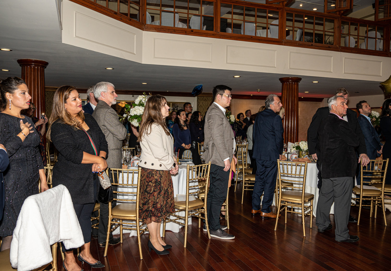 Attendees stood when seven past   chamber      presidents and the current   president were honored, left.